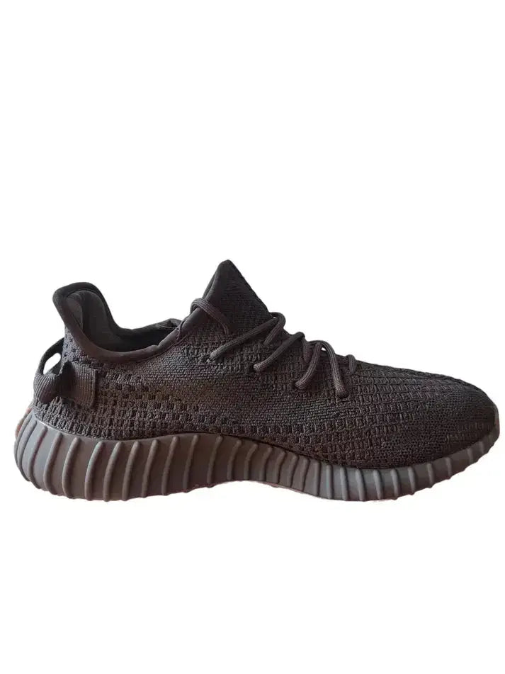 Adidas Yeezy 350 V2 Cinder sneaker in black with textured design and boost sole, side view.