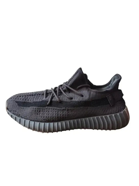 Adidas Yeezy 350 V2 Cinder sneaker in black with a distinctive ribbed sole, side view on a white background.